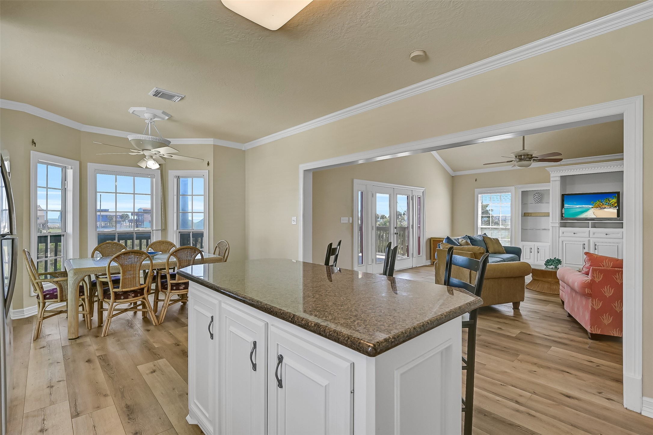A view of the open kitchen, dining, and living spaces.