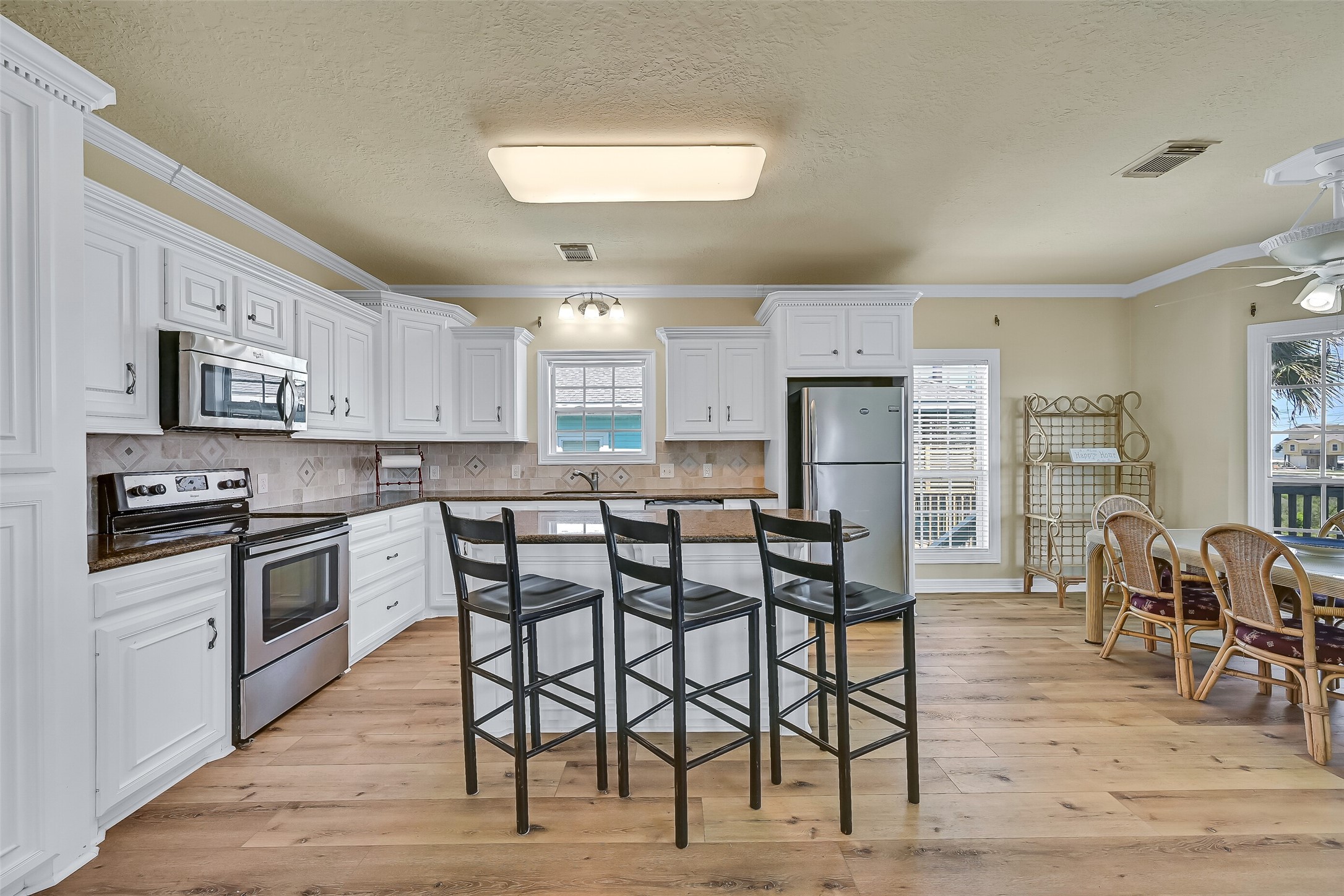 The spacious island with breakfast bar accommodates seating for 3.