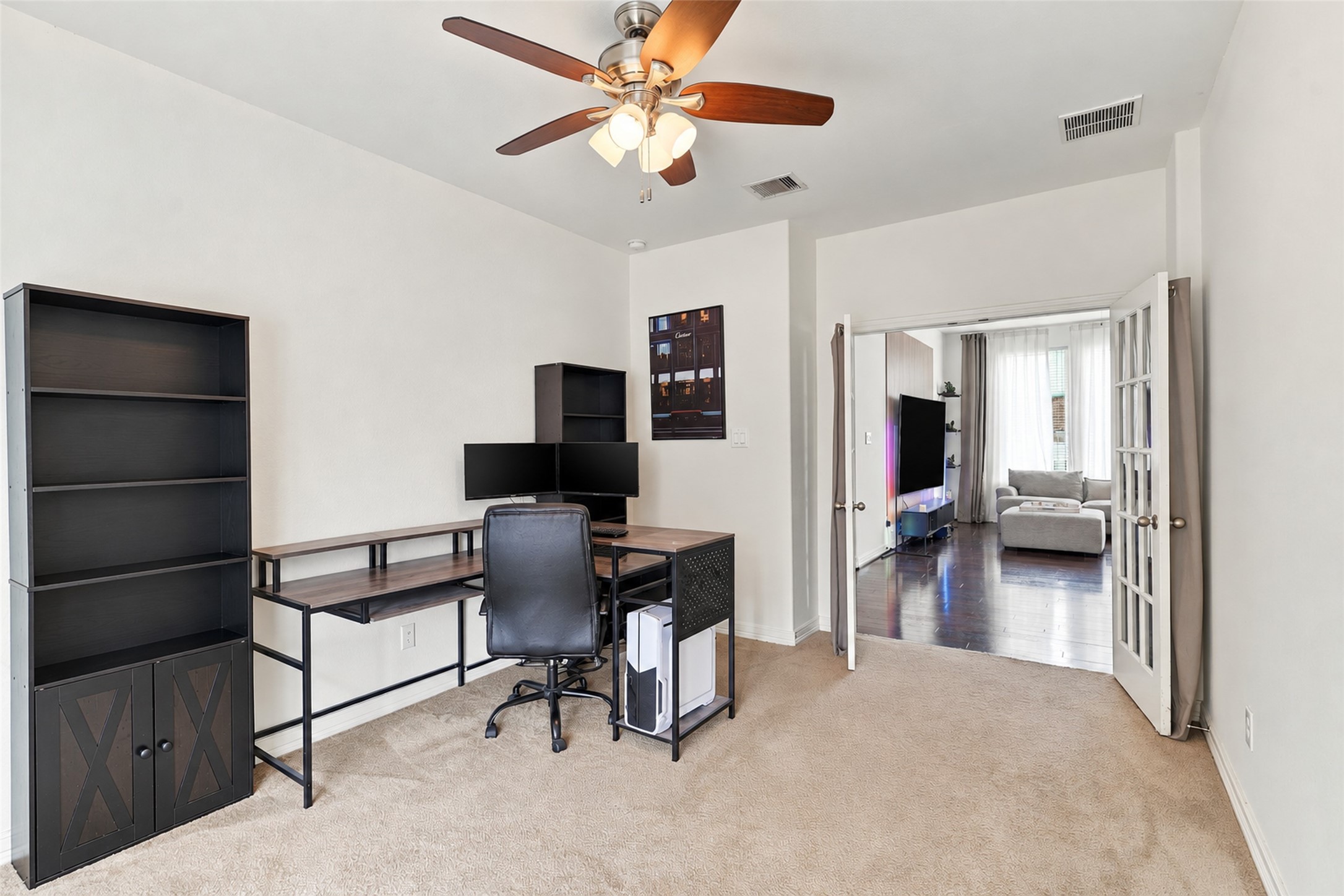 Alternate view of the office, with French doors connecting to the main living area.