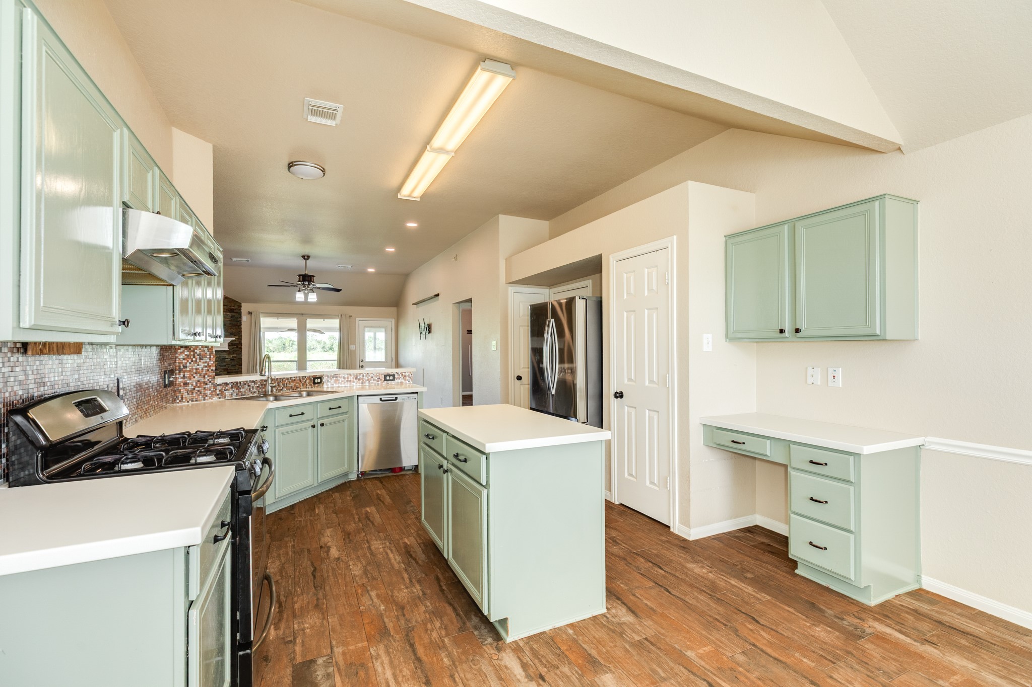 Kitchen features ample cabinetry plus built in workstation/desk area