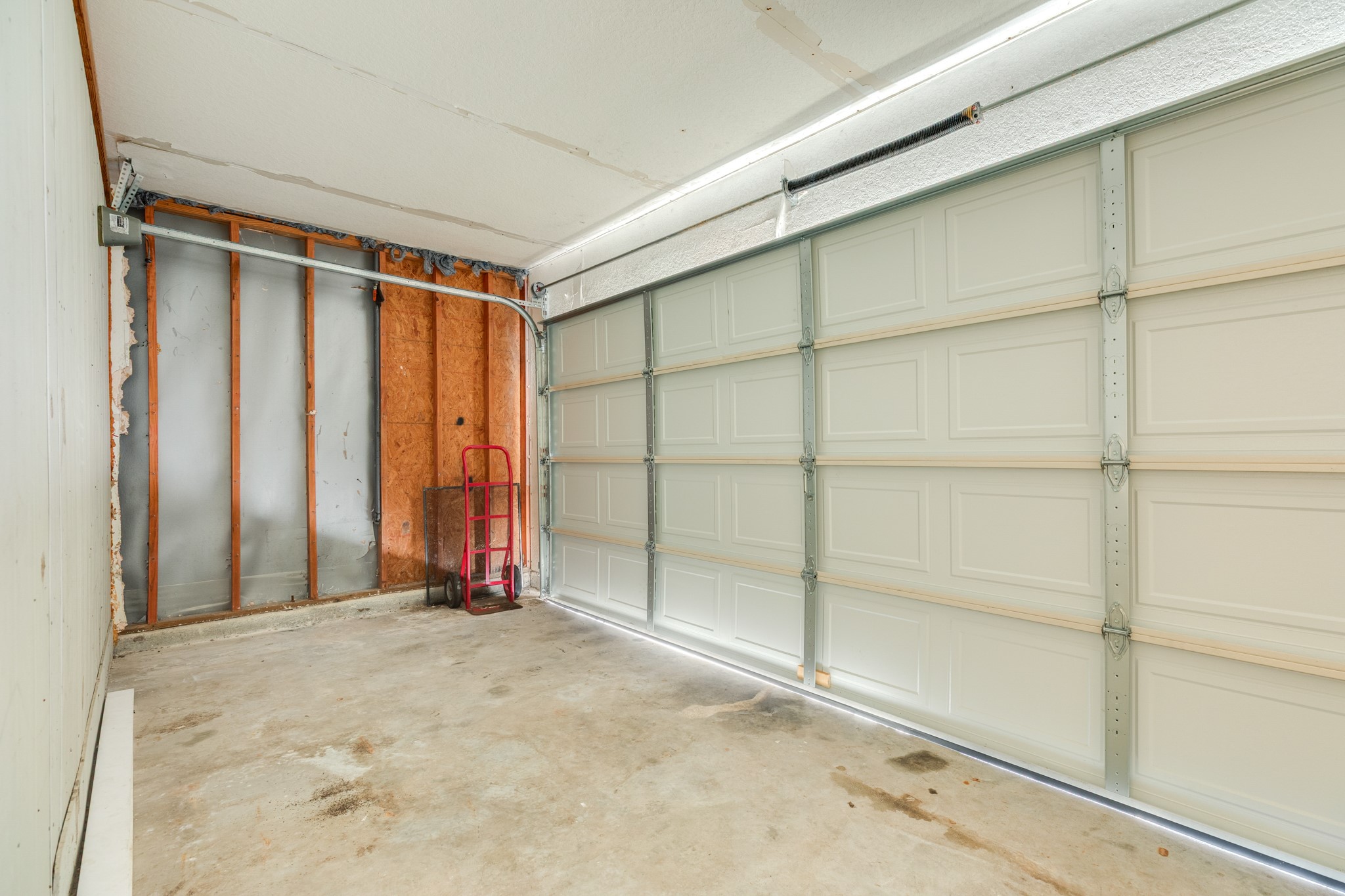 Storage area with garage door to driveway
