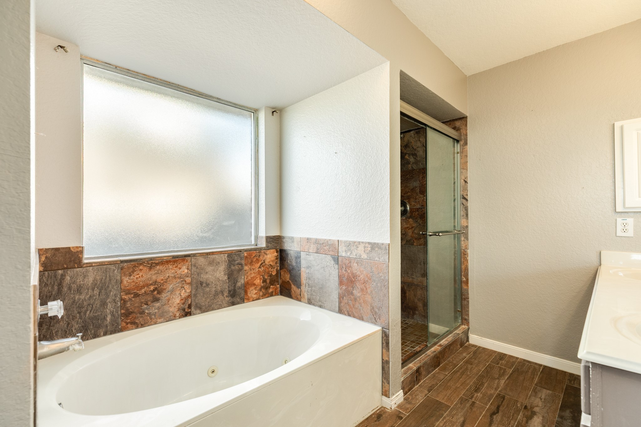 Separate jetted tub and freestanding shower