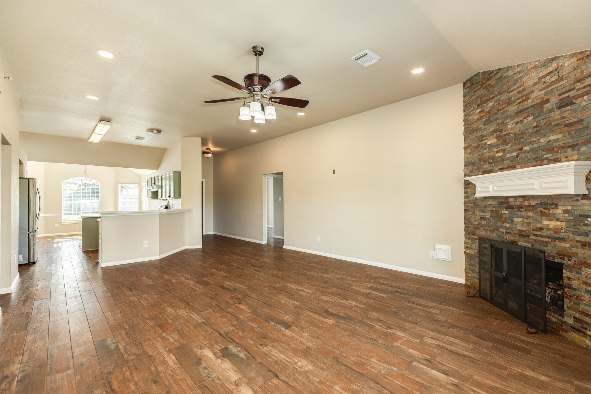 Spacious open-concept living area, and a modern kitchen with a breakfast bar, all illuminated by abundant natural light.