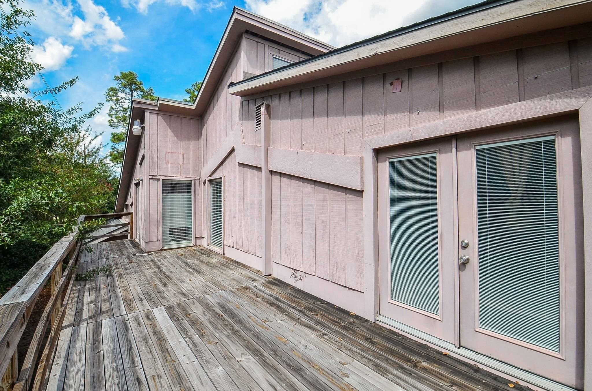 Upper-level patio deckperfect for morning coffee or stargazing. Connected to the lower level by an exterior staircase with a door at the base that resembles an attic door.