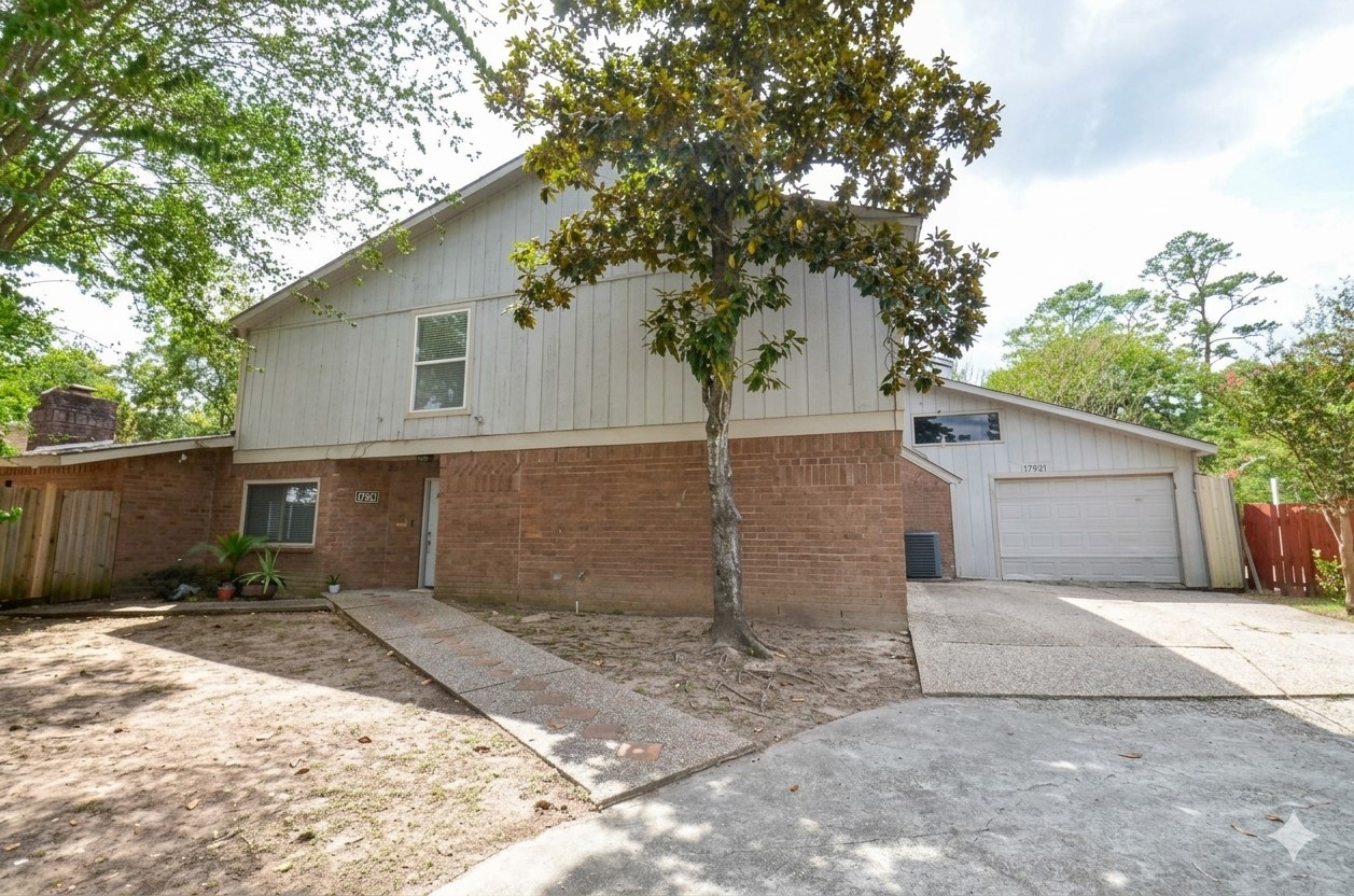Welcome to your new home! Exterior view of a two-story home featuring classic brick and siding.