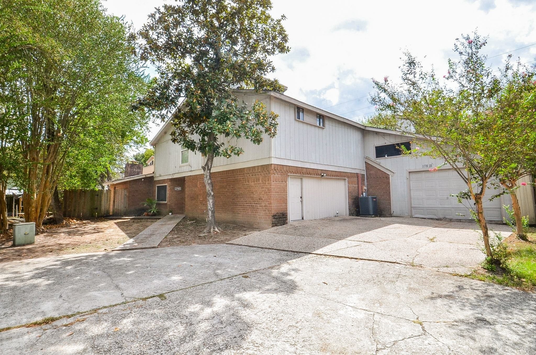 Ample parking with an extra-long driveway and multiple garage bays. Note: the left-side two-car bay is currently enclosedno overhead doorand finished with drywall, with a single service door providing interior access.