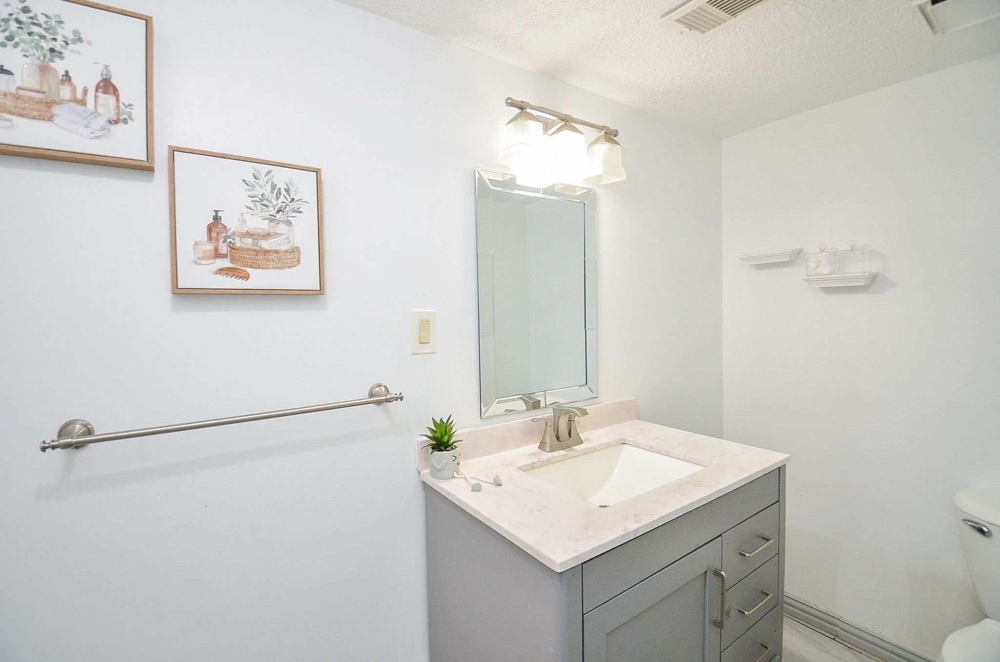 Take a look at this beautiful half-bath with gorgeous countertops and vanity mirror.