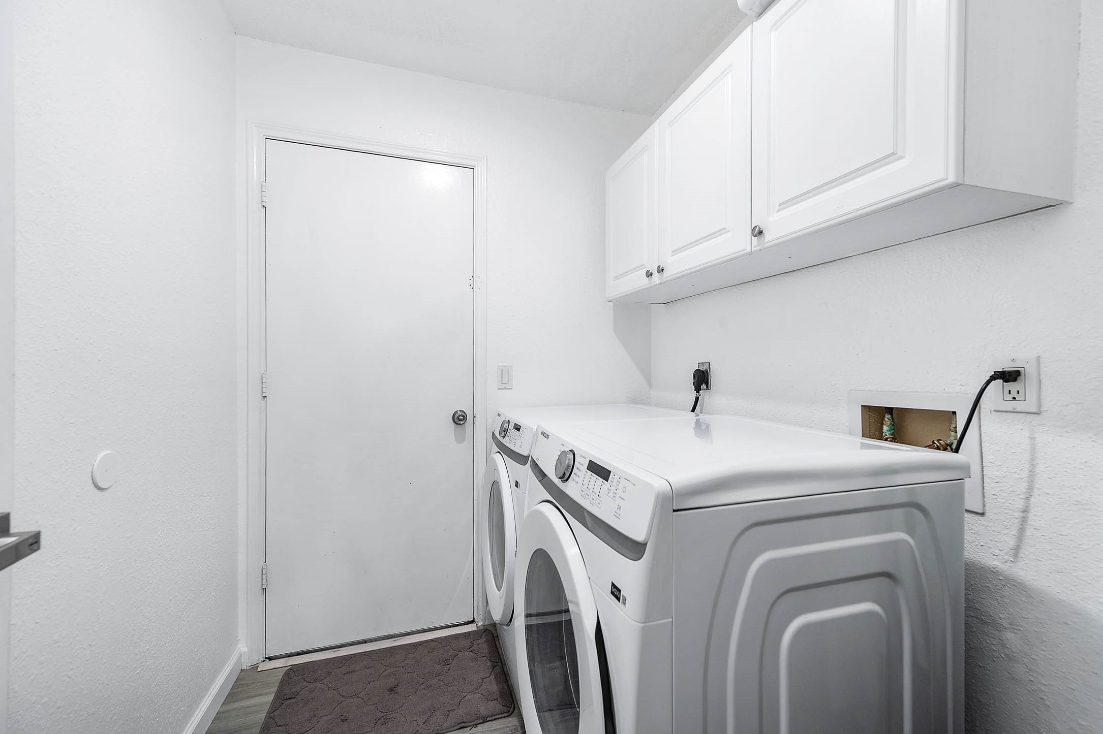 The laundry room features
washer/dryer connections and cabinetry with plenty of storage
space!