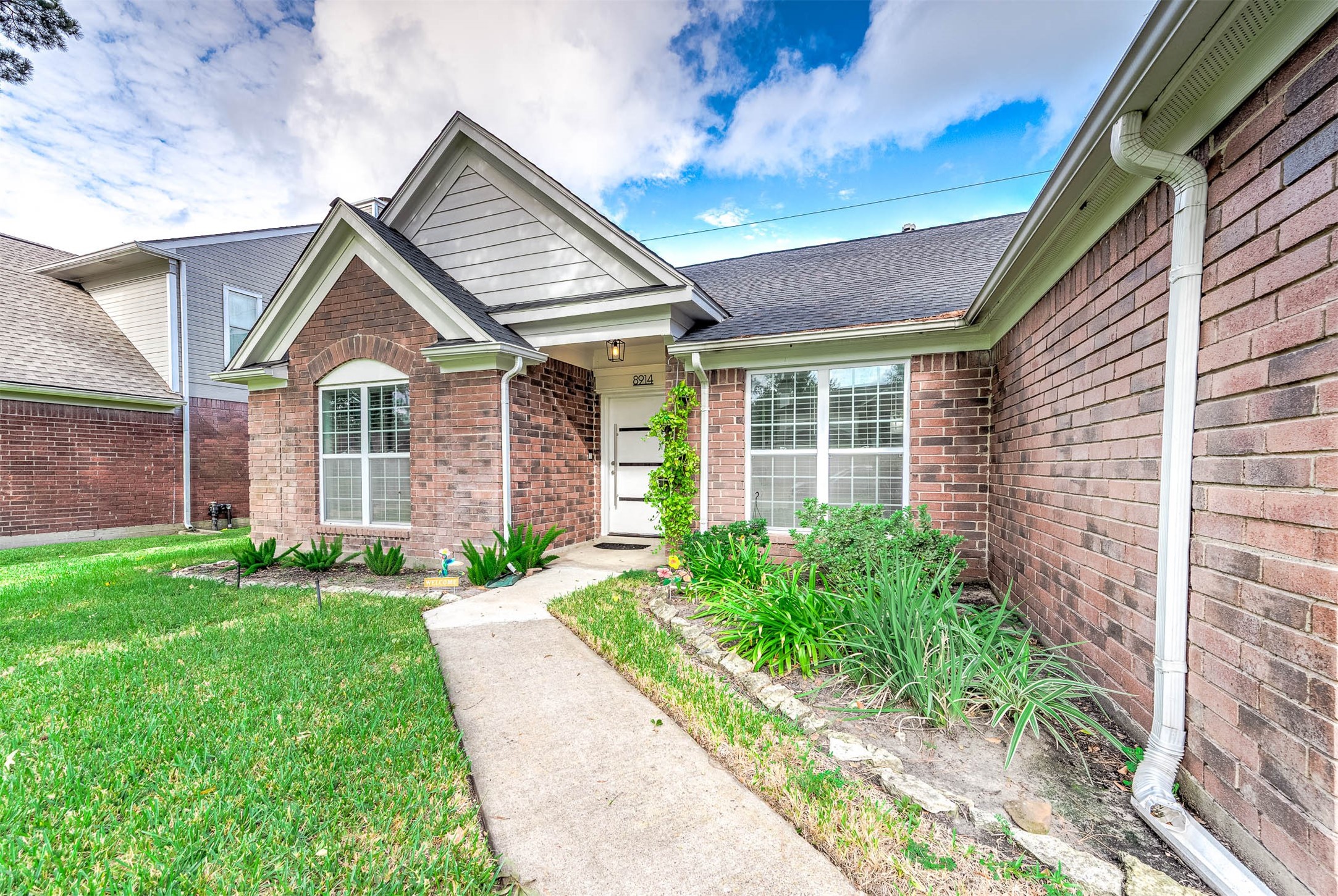 Approaching the front door you will
see the beautiful brick elevation,
covered front porch, and lovely
landscaping! Approaching the front door you will
see the beautiful brick elevation,
covered front porch, and lovely
landscaping!