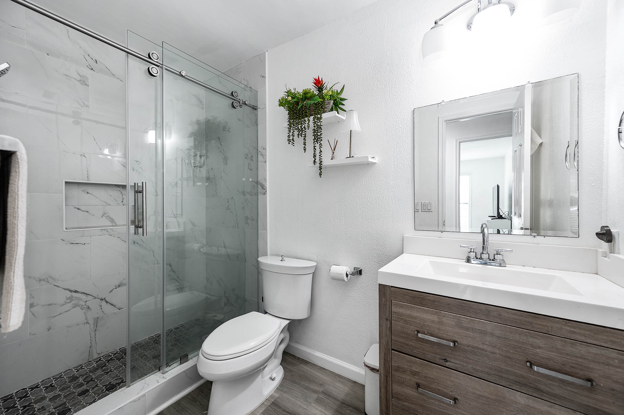 Secondary bathroom features light
countertops, dark cabinets, shower with tile surround 
and tile floors!