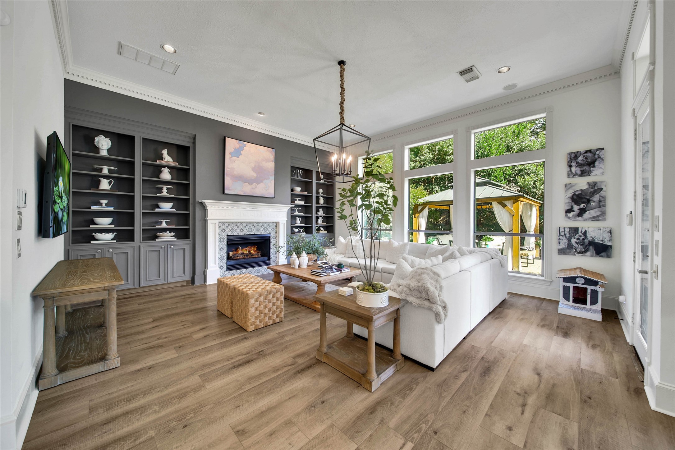 Spacious family room with a warm fireplace, elegant built-in shelves, and abundant natural light.