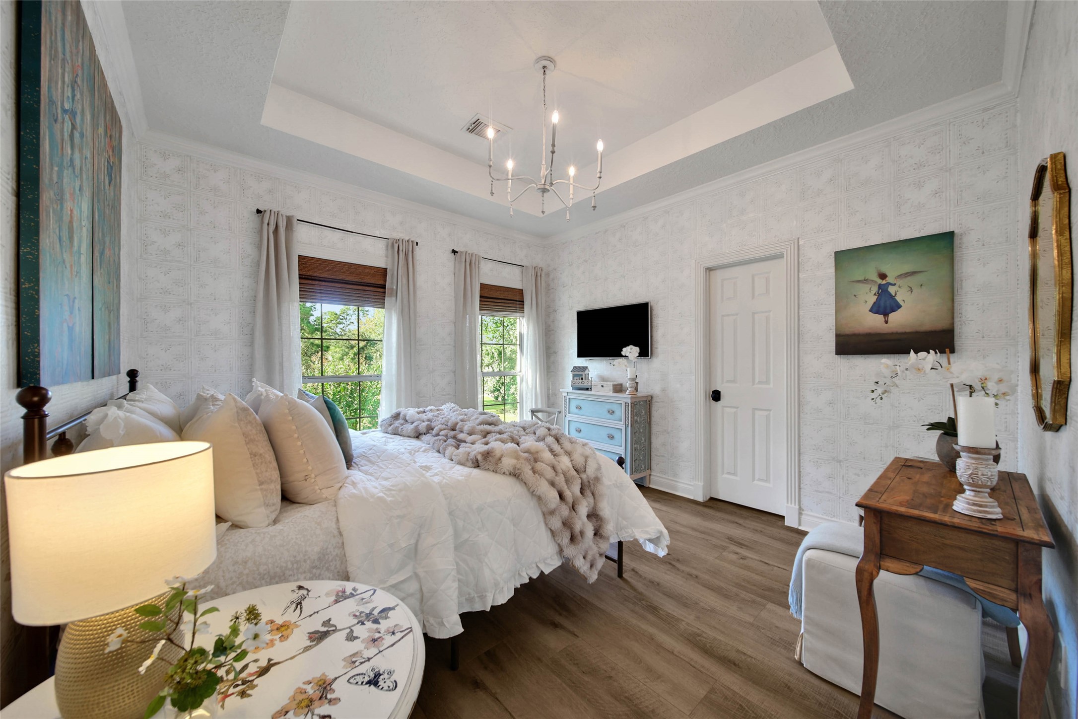 Cozy guest bedroom with elegant decor and abundant natural light.