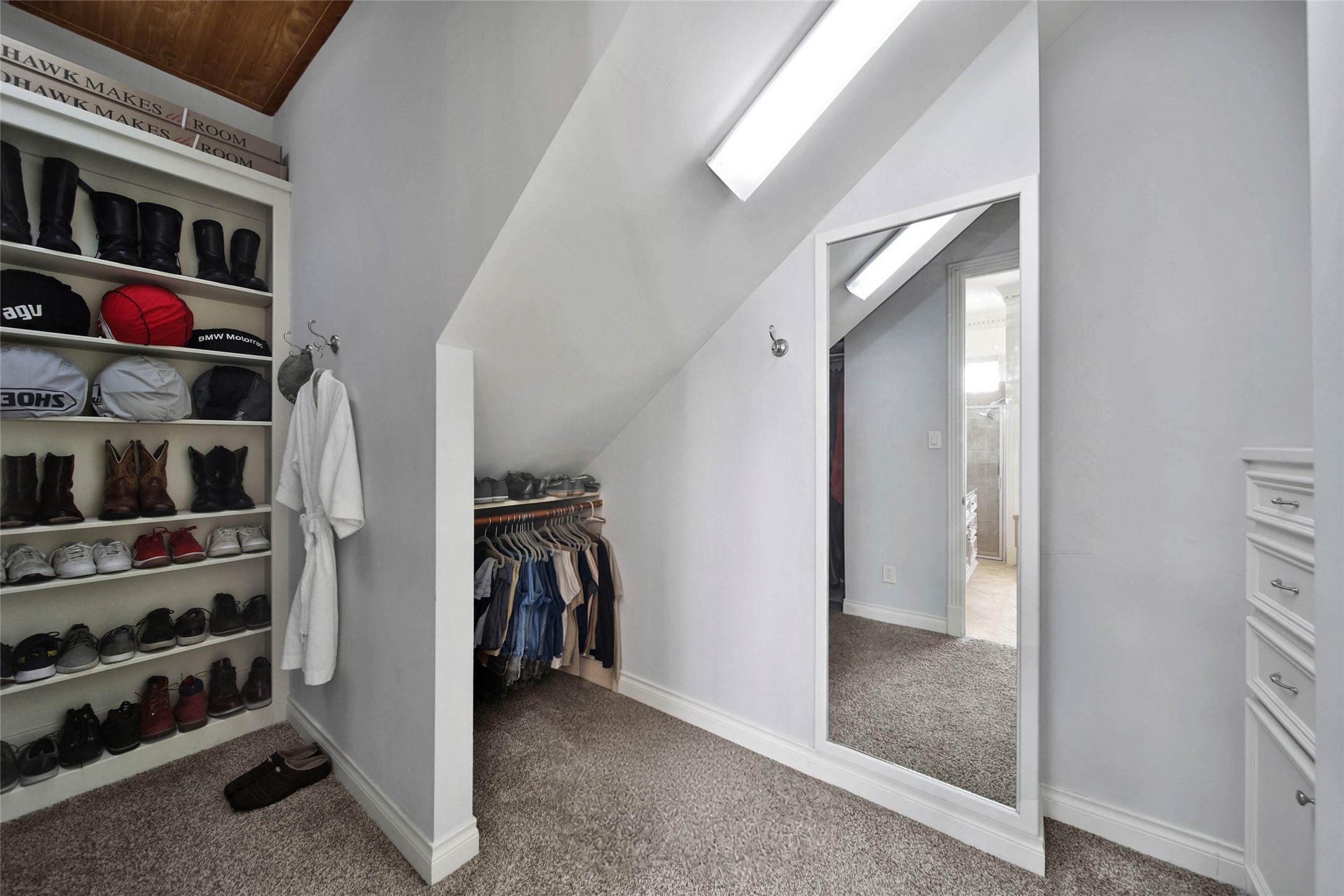 His closet features custom built-ins, offering organized and stylish storage for shoes and accessories.