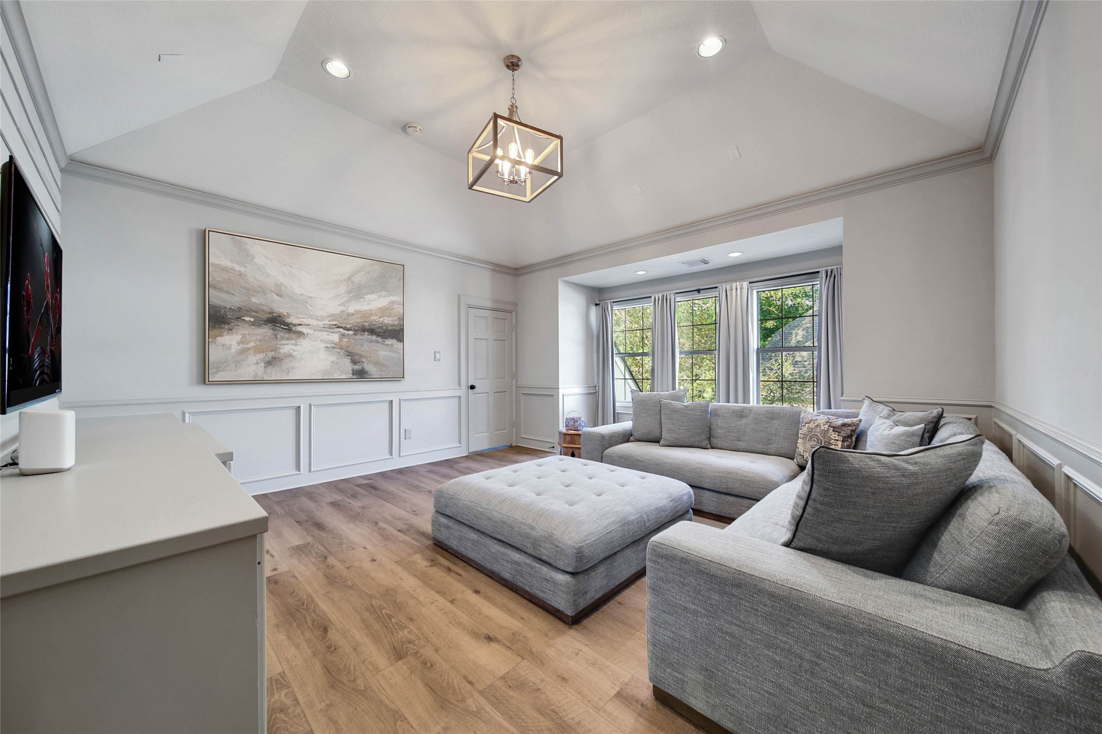 Elevate your leisure time in this inviting game room, featuring ample natural light and cozy seating for ultimate relaxation and entertainment.
