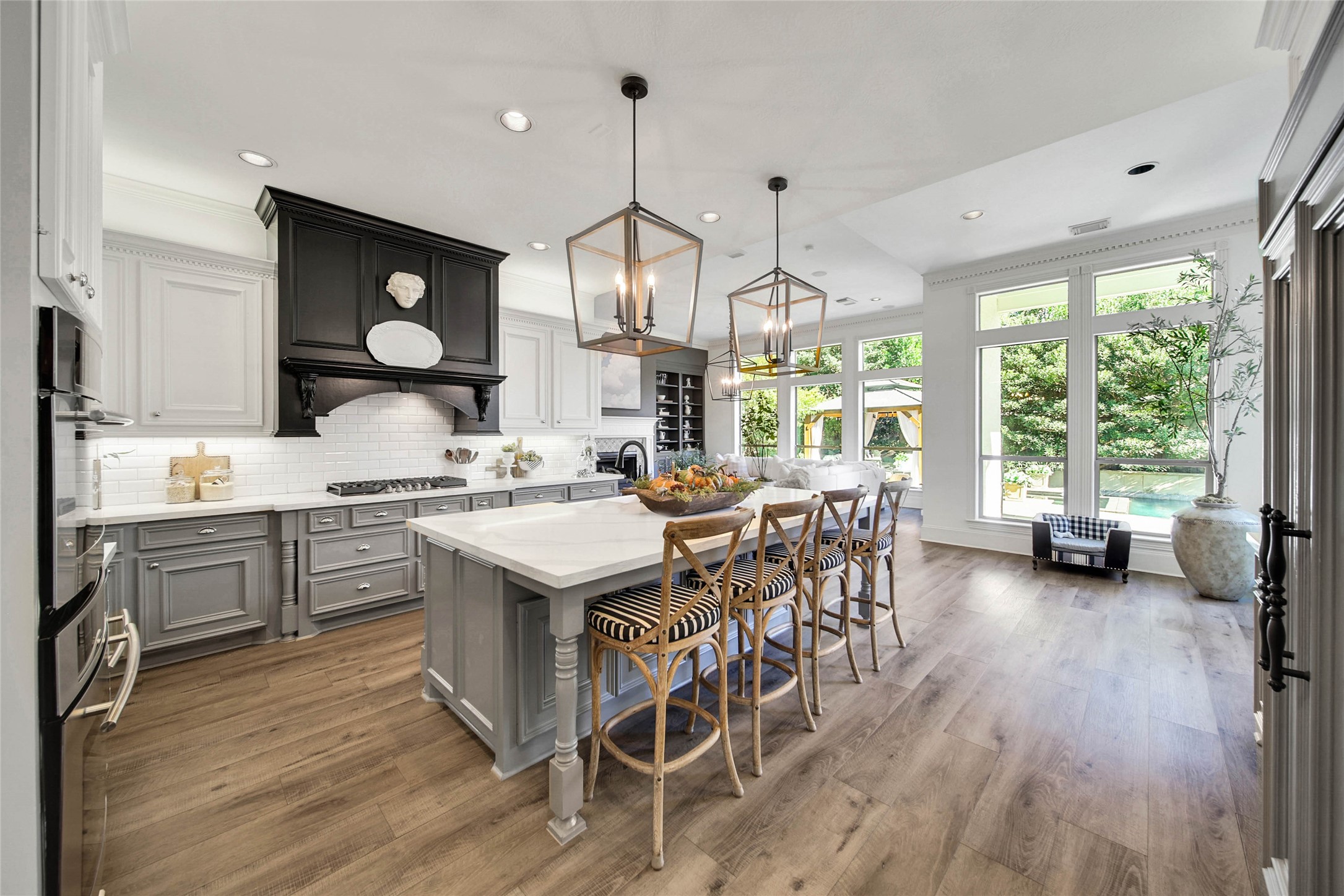 Stylish Kitchen features oversized island, SS appliances, Built-in Fridge and high end finishes.