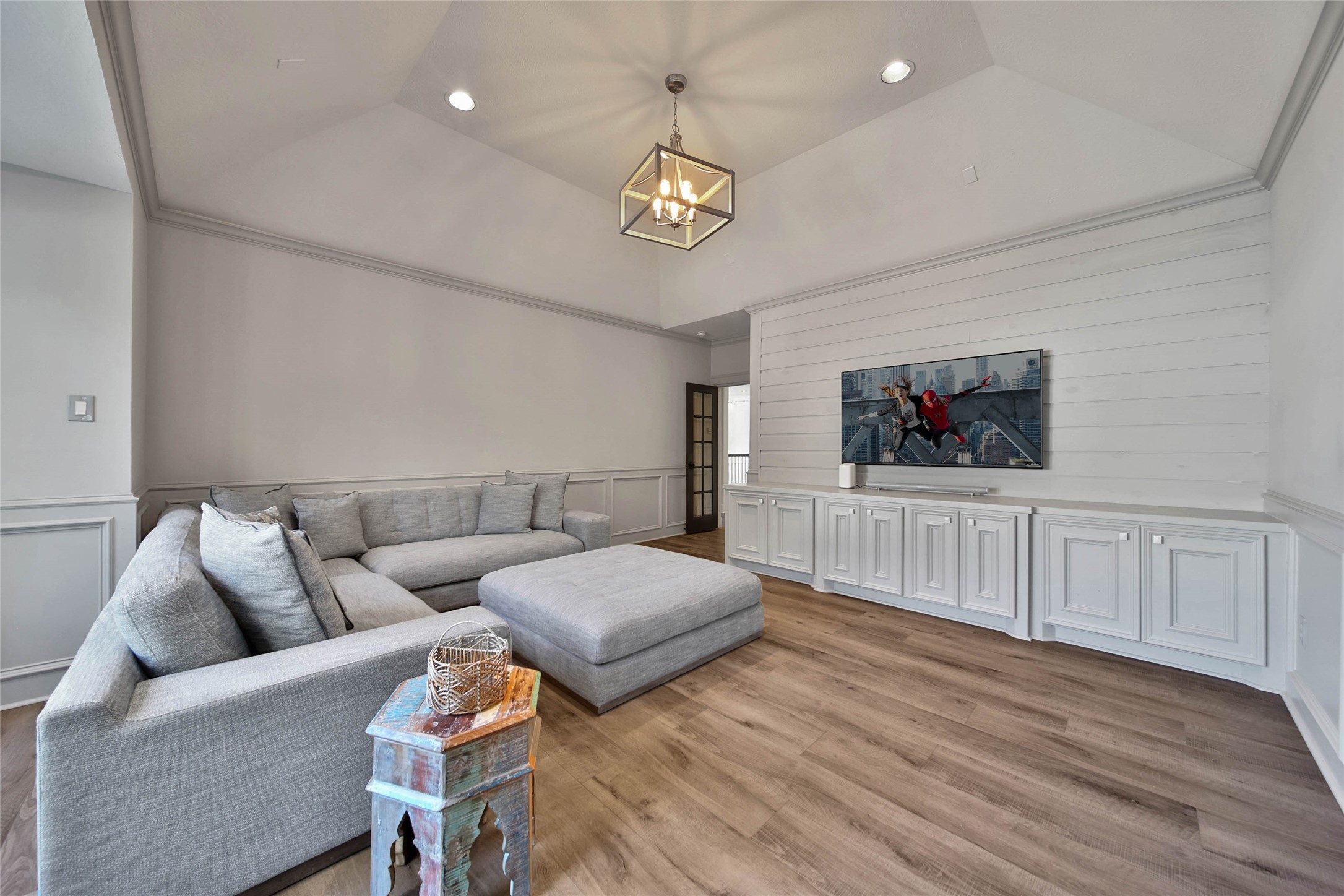 Stylish built-ins in the game room offer ample storage and a seamless entertainment setup.