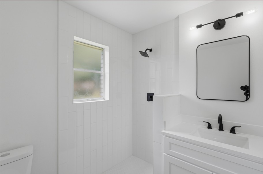 The primary bathroom features a modern standing shower, creating a clean and functional space designed for everyday comfort. Thoughtful finishes and a simple layout provide a fresh, inviting atmosphere.