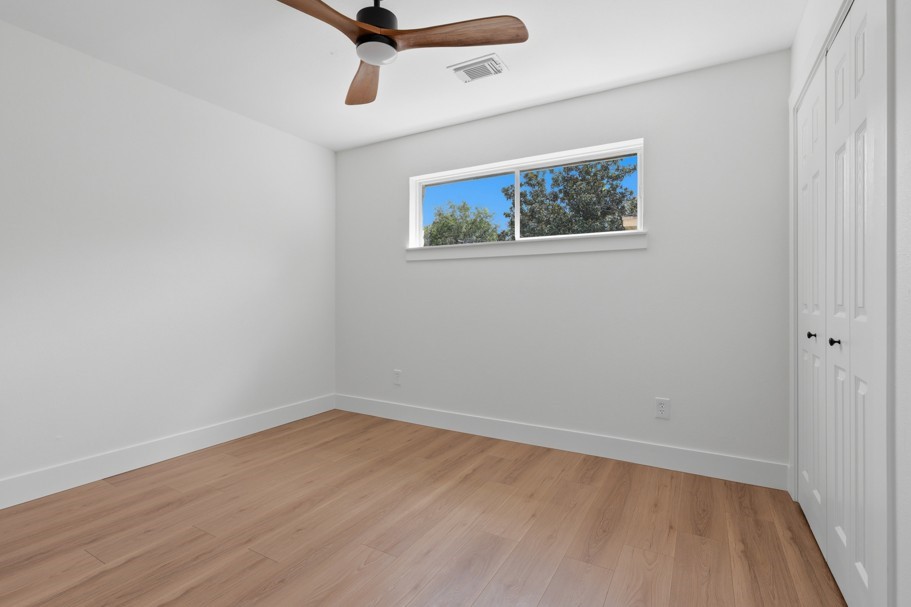 The spacious bedrooms are complemented by abundant natural light, beautiful wood floors, and new ceiling fans, creating a comfortable and inviting retreat.