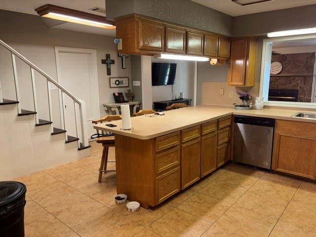 As you enter the front door the kitchen is just to your right. The door near the stairs goes to the garage and the stairs go to the Primary Bedroom.