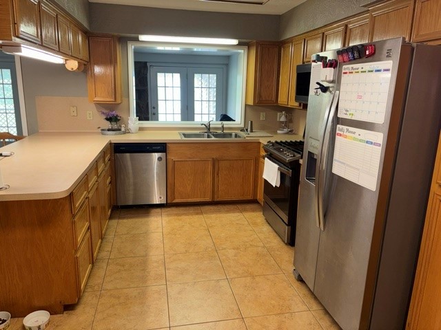 Another view of the kitchen. Notice the opening above sink that looks into the family room.