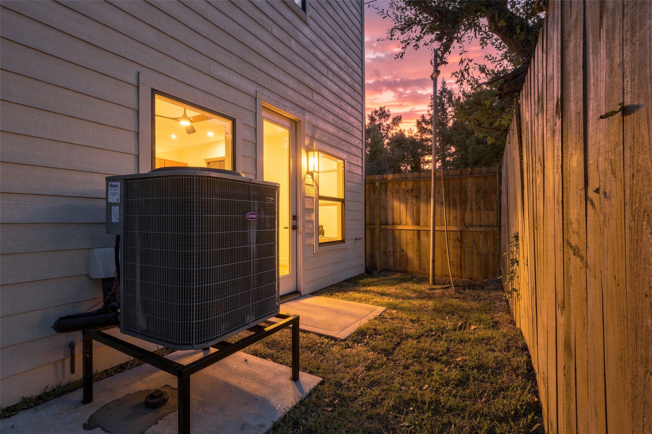 The backyard space features a fenced area and convenient access to the interior, perfect for relaxing evenings.