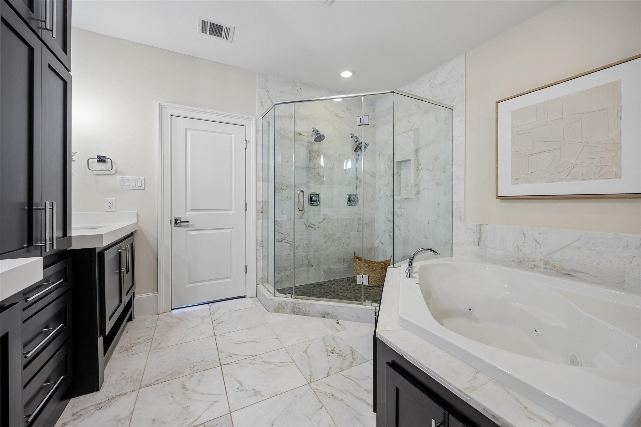 The ensuite bath pampers you with a glass enclosed shower with dual shower heads and a large, jetted tub.