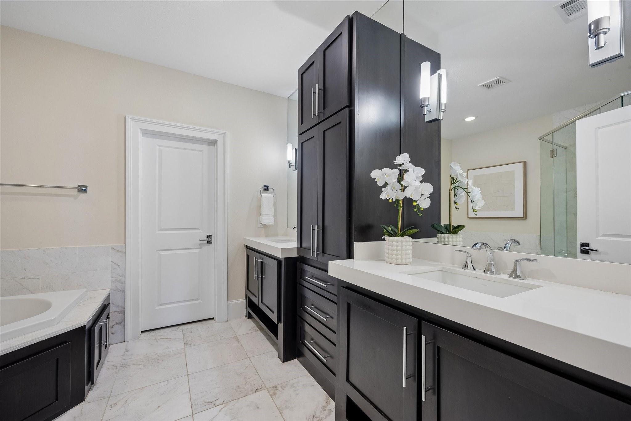 Dual sinks, generous storage, and a thoughtful layout make preparing for the day both convenient and efficient.