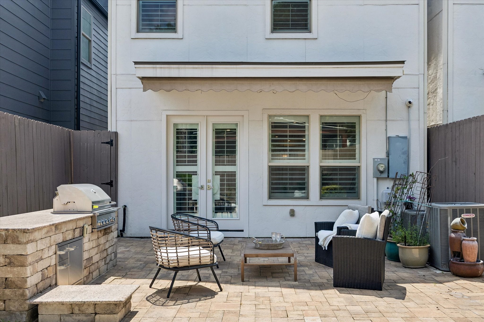 A built-in grill paired with a granite countertop offers an ideal setting for outdoor cooking and entertaining.