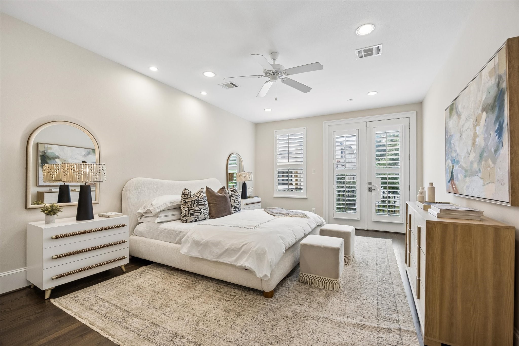 Retreat to the spacious primary suite, complete with a private balcony, hardwood floors, recessed lighting, a ceiling fan, and a spa-like ensuite bathroom. Retreat to the spacious primary suite, complete with a private balcony, hardwood floors, recessed lighting, a ceiling fan, and a spa-like ensuite bathroom.