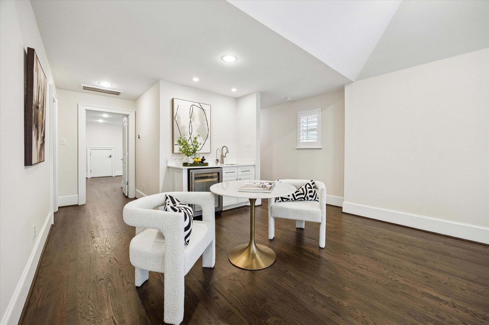 A wet bar and beverage refrigerator enhance the space, making it perfect for entertaining.