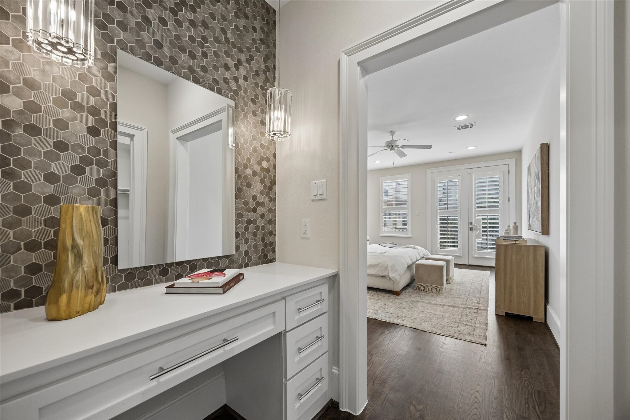 Vanity with storage, statement tile backsplash, and stylish pendant lighting.