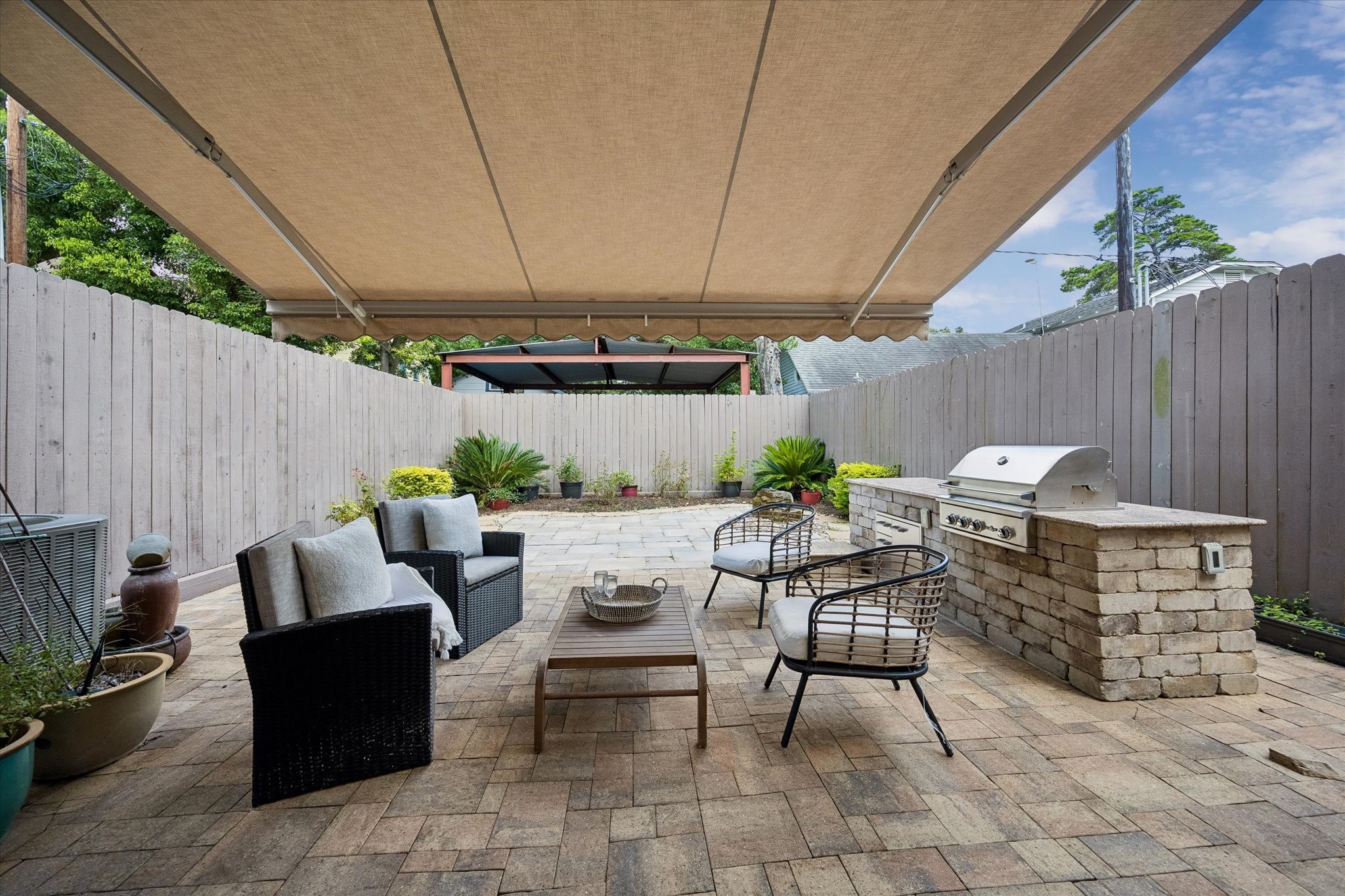 A retractable awning provides flexible shade, perfect for enjoying the outdoors during hot summer months.