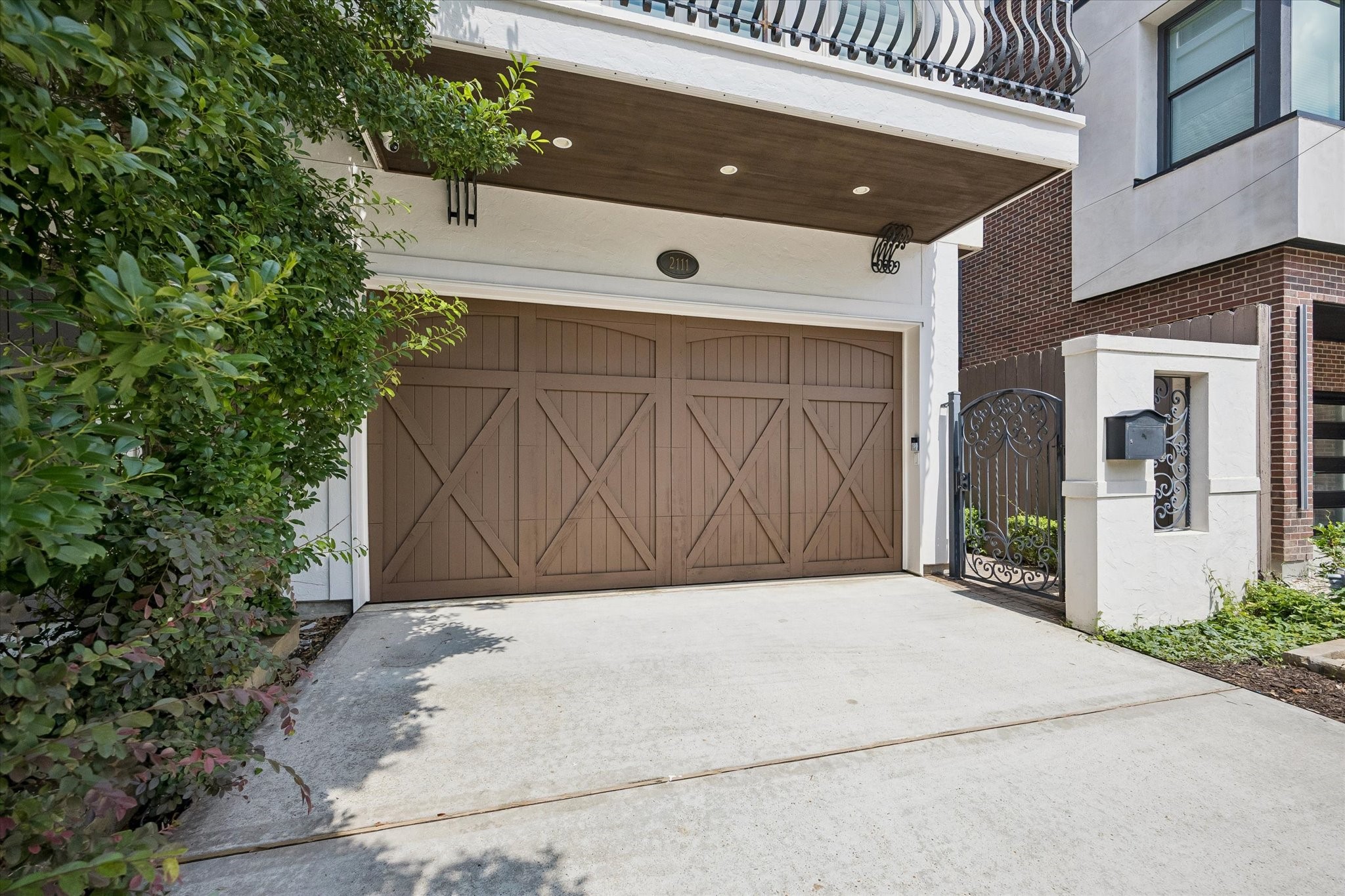 A double-wide driveway and two-car attached garage with epoxy flooring and extra storage offer both luxury and everyday convenience.
