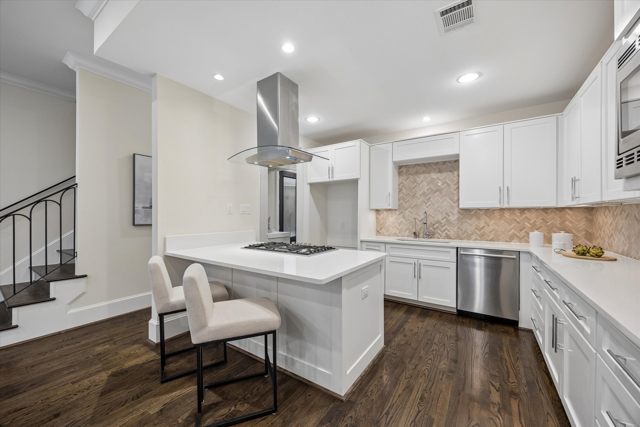 A chefs kitchen featuring Bosch appliances, Silestone counters, and an island with breakfast bar. A chefs kitchen featuring Bosch appliances, Silestone counters, and an island with breakfast bar.
