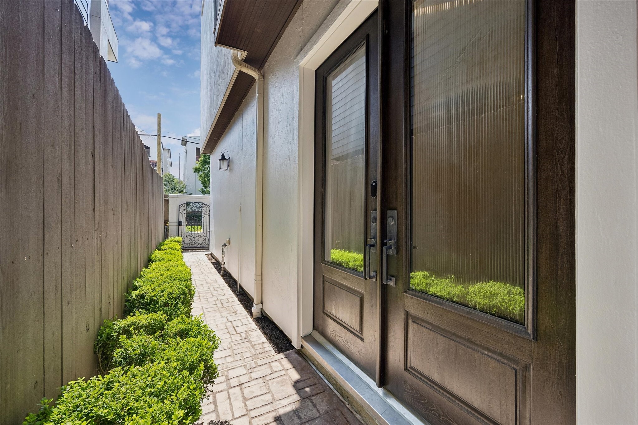 Set behind an iron gate, the front entry offers a private and secluded feel.