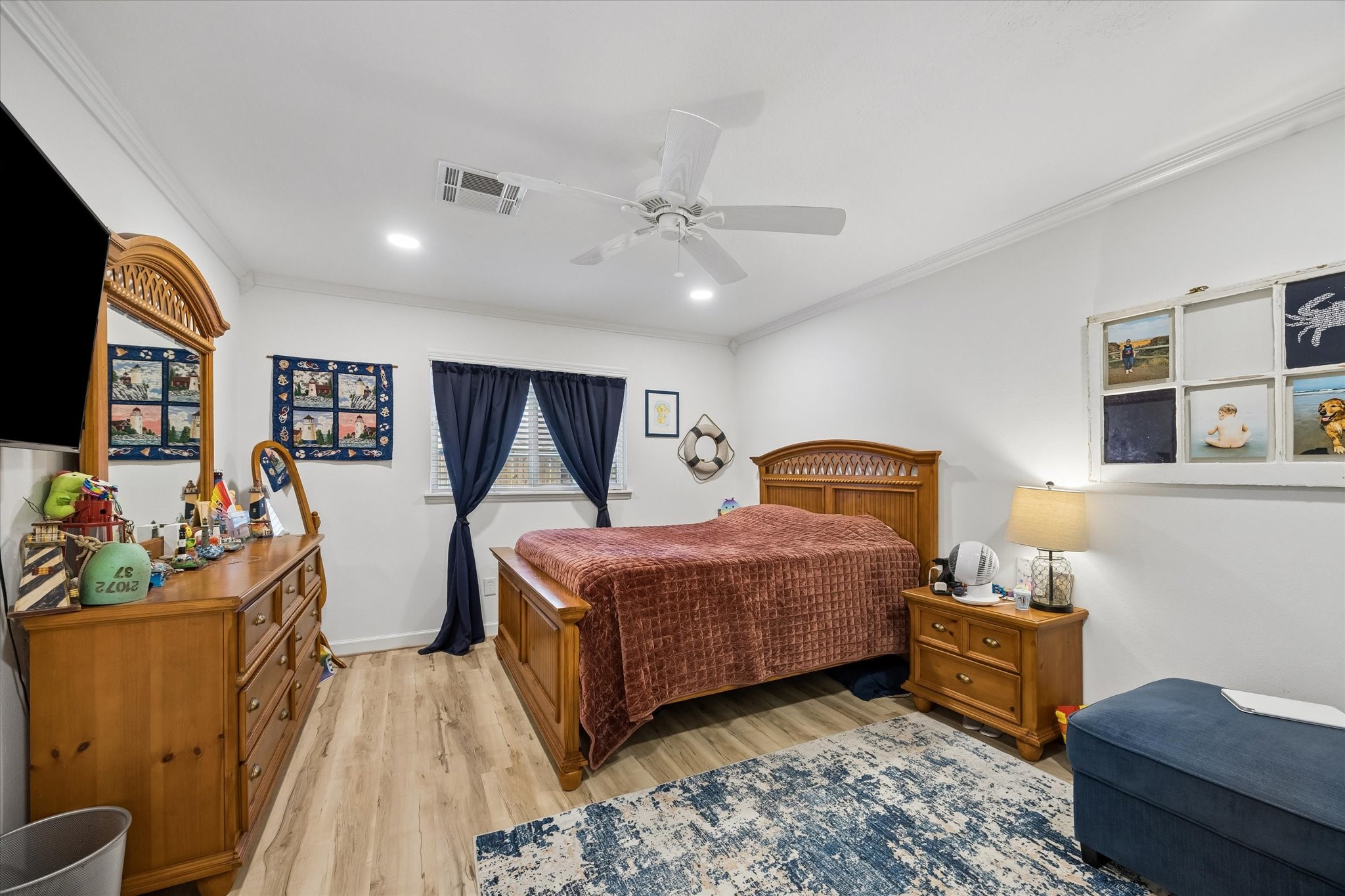 Spacious primary bedroom boasts high-end LVP flooring, upgraded dual pane windows, recessed lighting & luxurious baths with 2 walk-in closets.