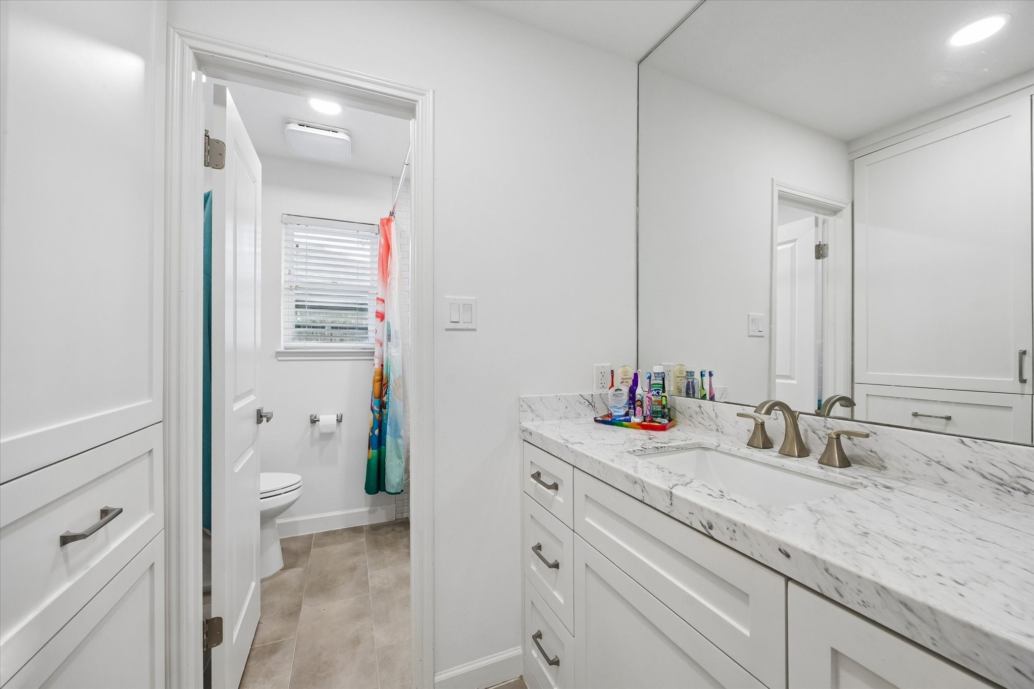 Beautifully renovated secondary bath boasts quartz counters with undermount sink, upgraded cabinet doors, tile flooring & upgraded fixtures/hardware!