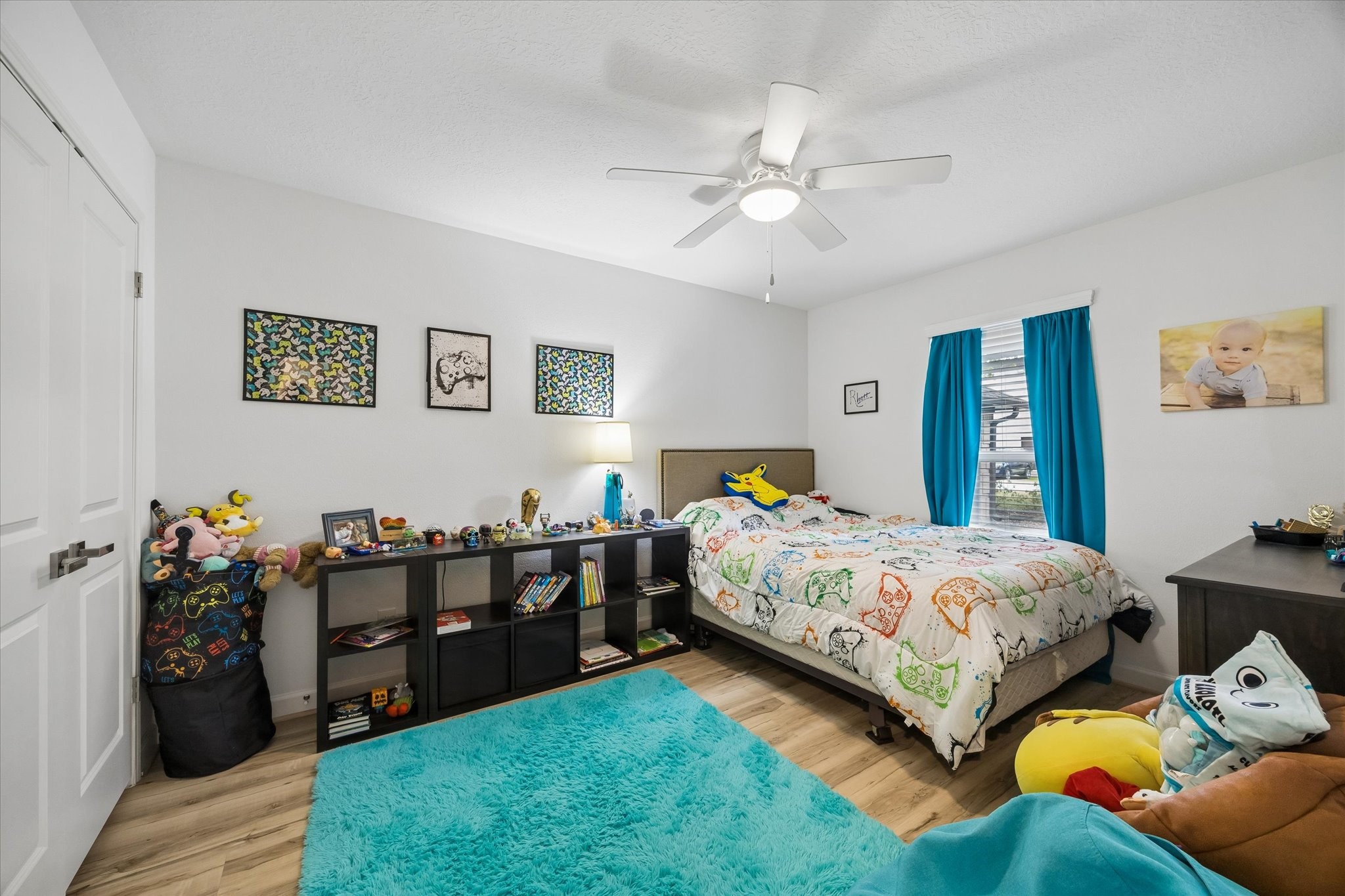 One of three spacious secondary bedrooms, all boasting high-end LVP flooring, upgraded dual pane windows, large closets & ceiling fans!