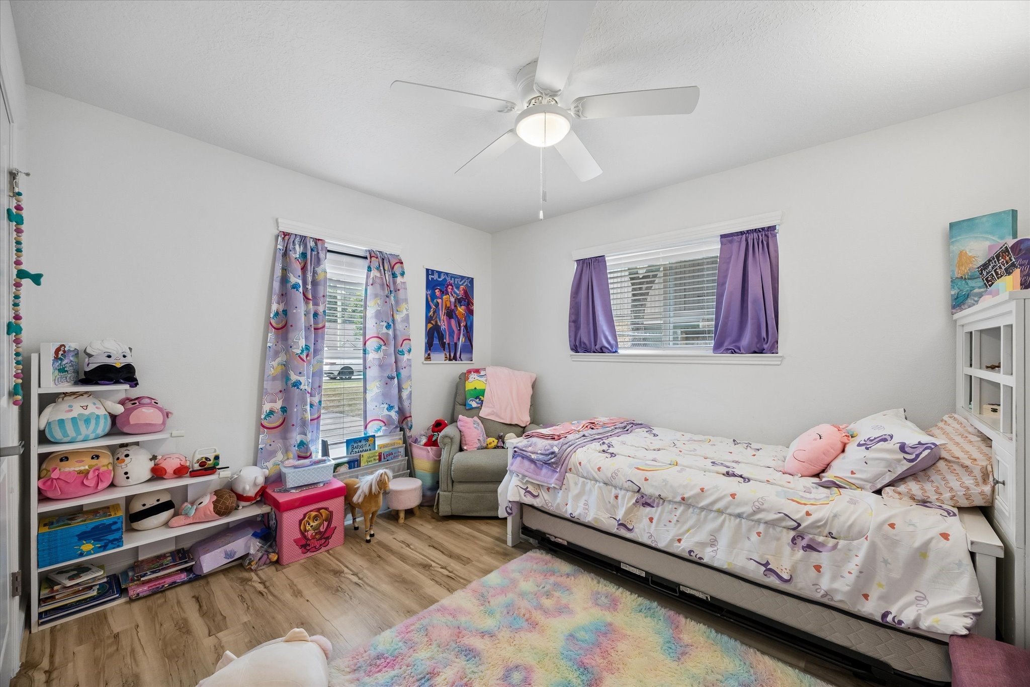 One of three spacious secondary bedrooms, all featuring 2" slat blinds & ceiling fans! All interior doors have been replaced throughout the home!