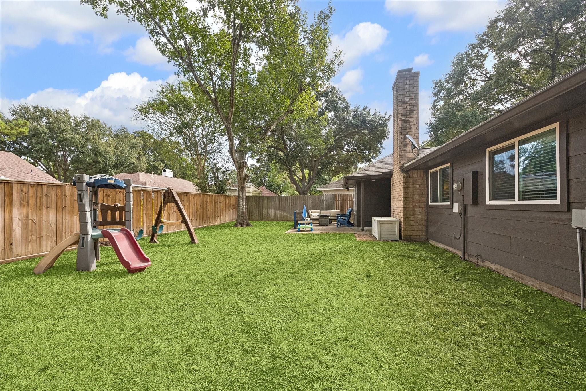 Another view of large yard with mature trees & back portion of fencing replaced.