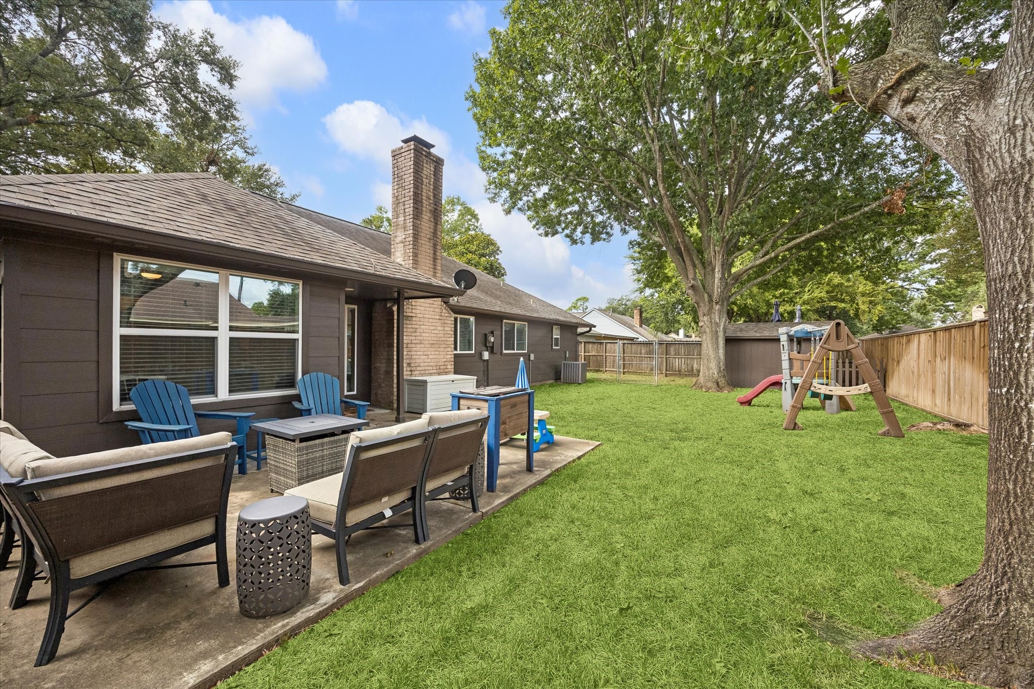 Another view of large yard with dog run & shed on the far end of the yard.