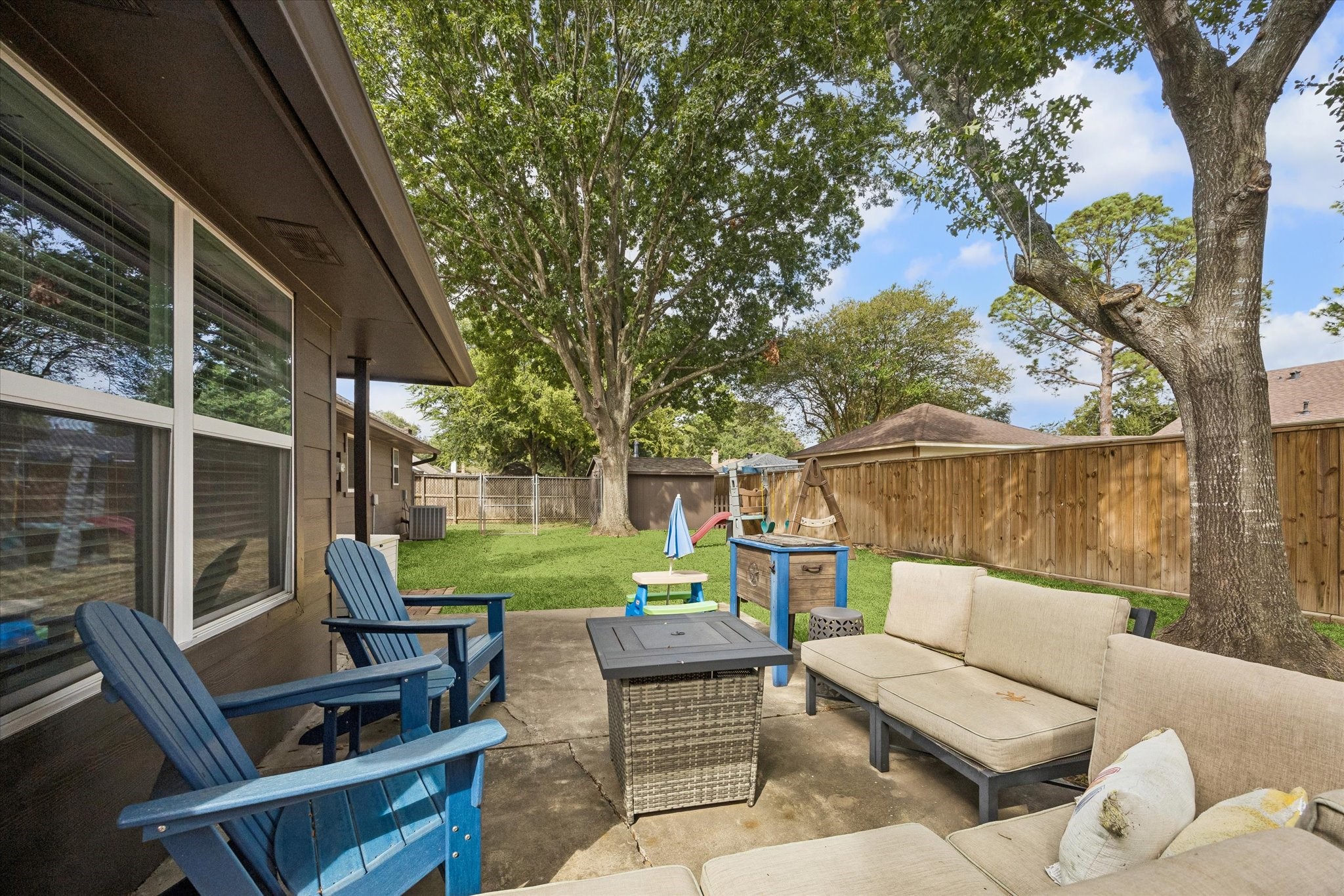 Secluded back porch graced by shade from mature trees is the perfect place to unwind!