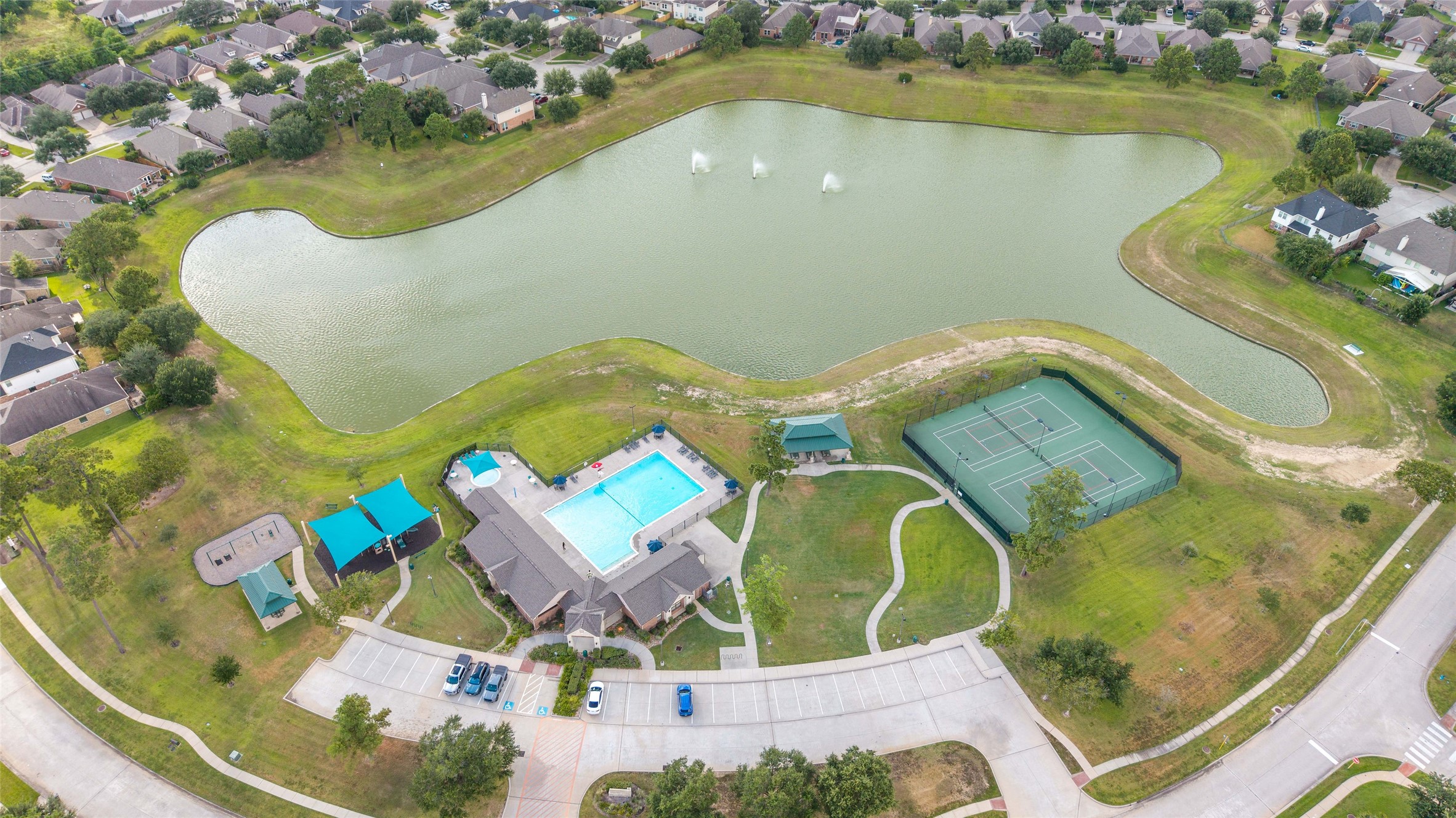 Aerial view highlighting the amenities, lake and walking trails.