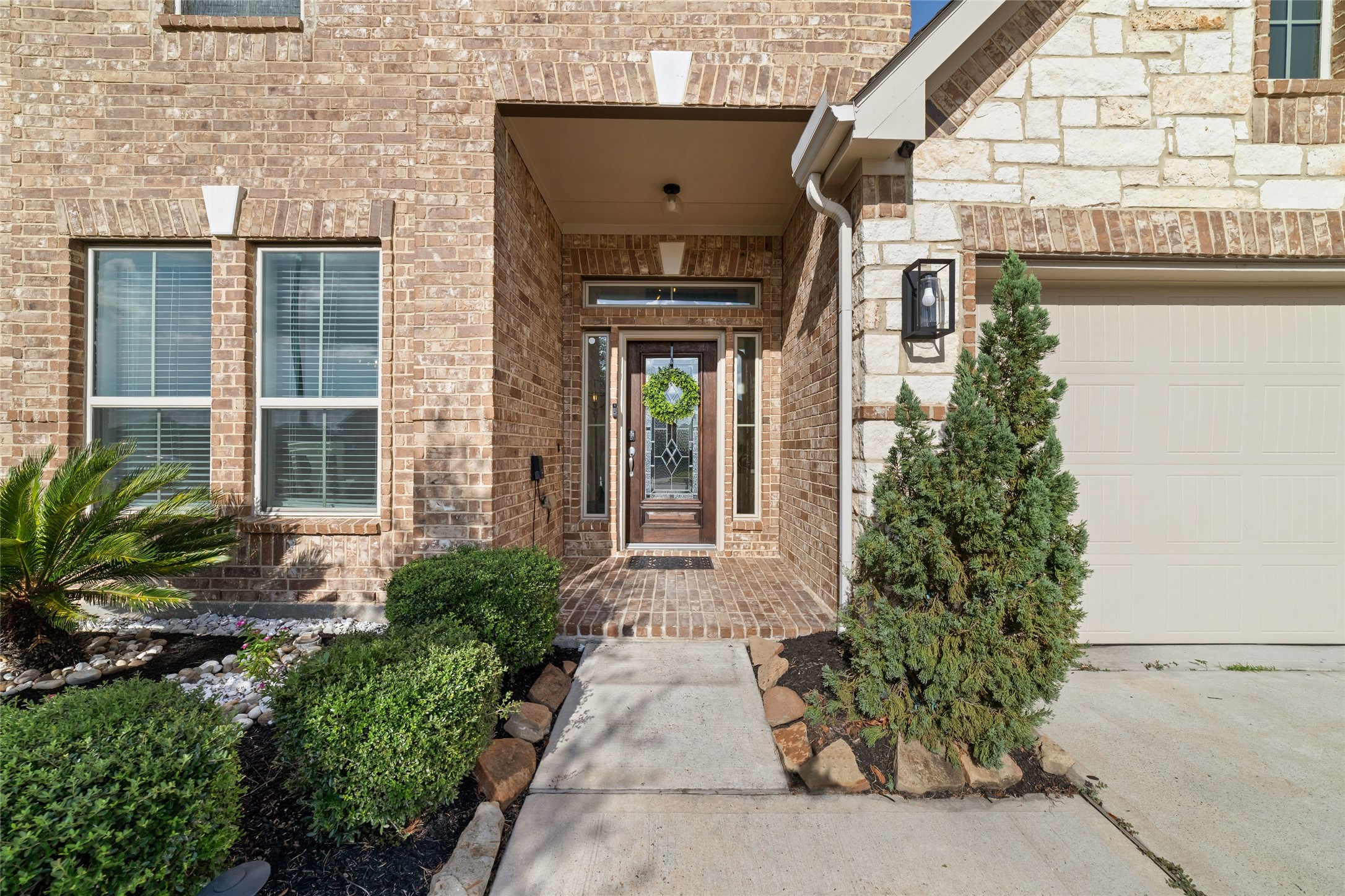Charming covered front entry with brick detailing and established landscaping. Charming covered front entry with brick detailing and established landscaping.
