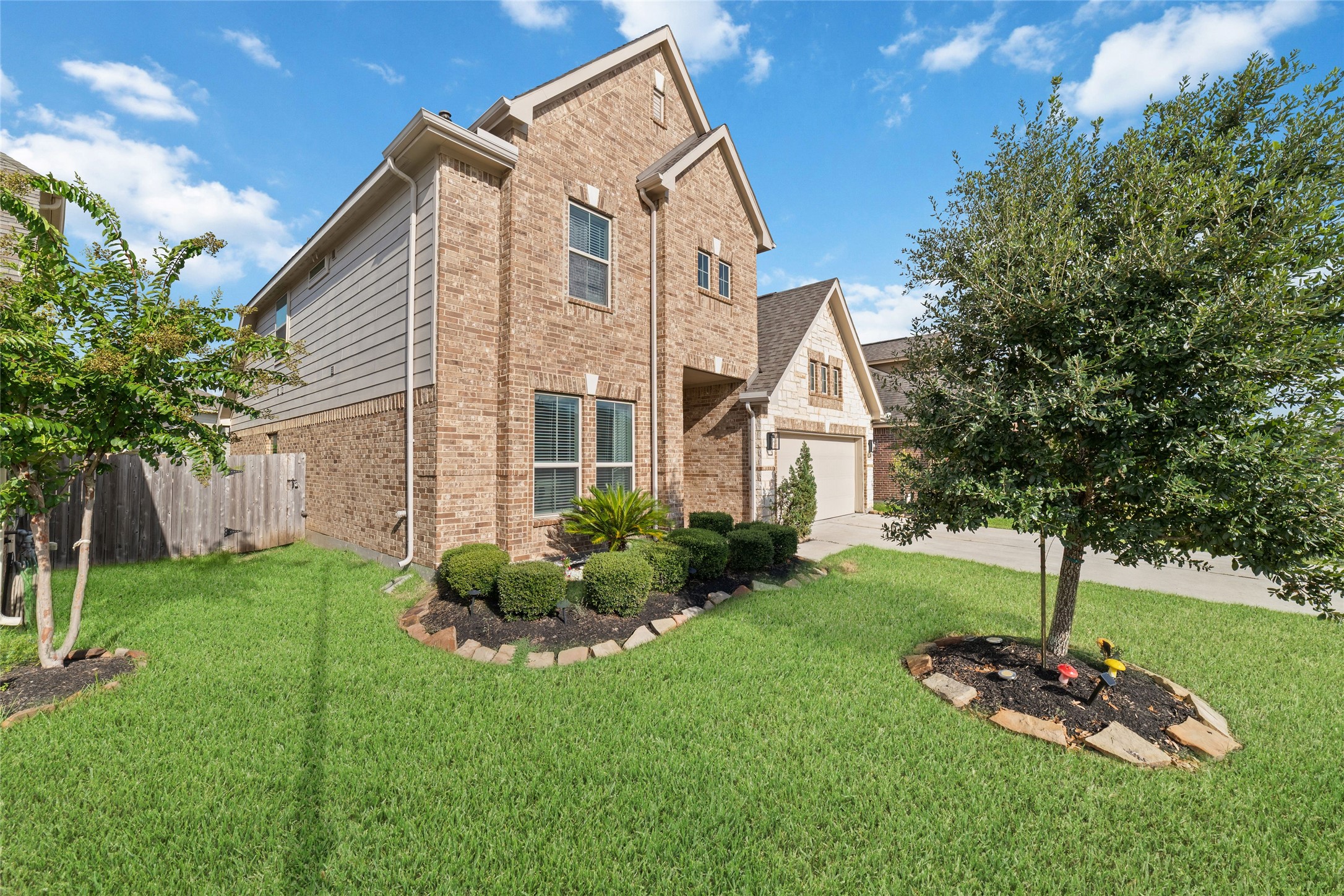 Charming curb appeal with mature trees and landscaping.