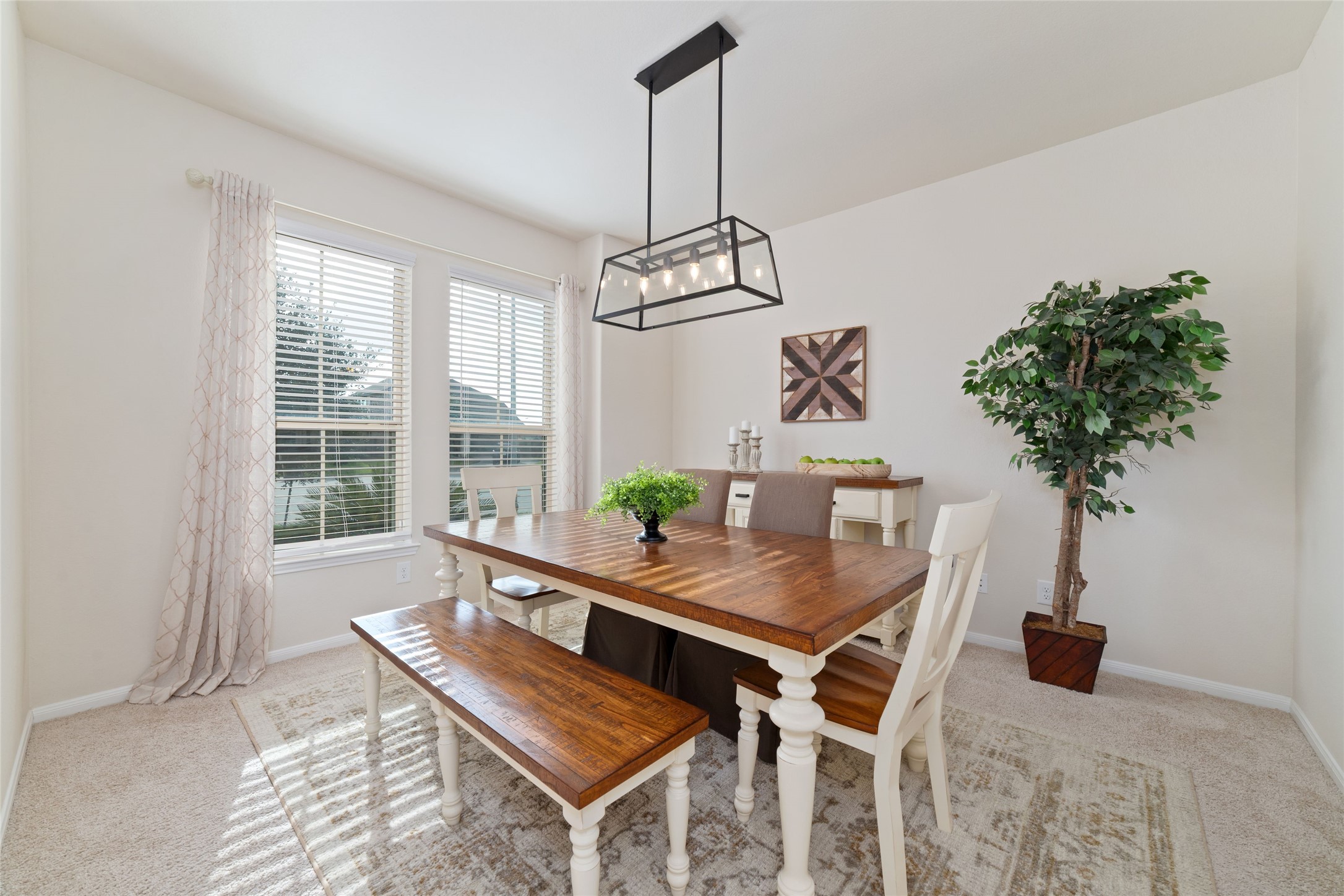 The formal dining room is right off of the entry with updated modern lighting The formal dining room is right off of the entry with updated modern lighting