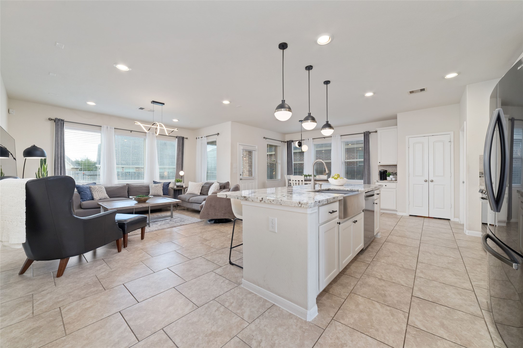 The open concept kitchen, dining and living areas create a bright, spacious layout perfect for everyday living and entertaining.