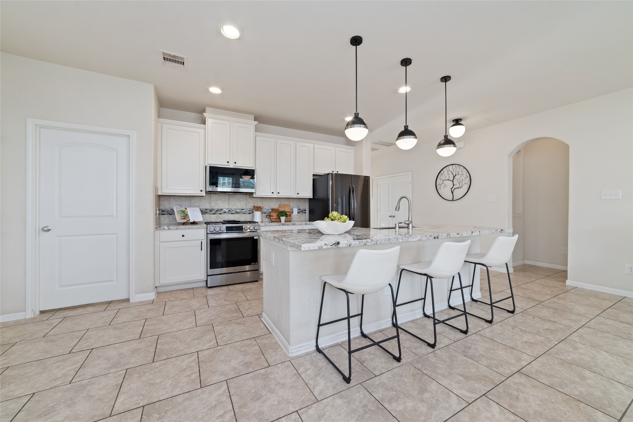 The spacious kitchen is open to the surrounding living areas, making it easy to cook, gather and entertain.