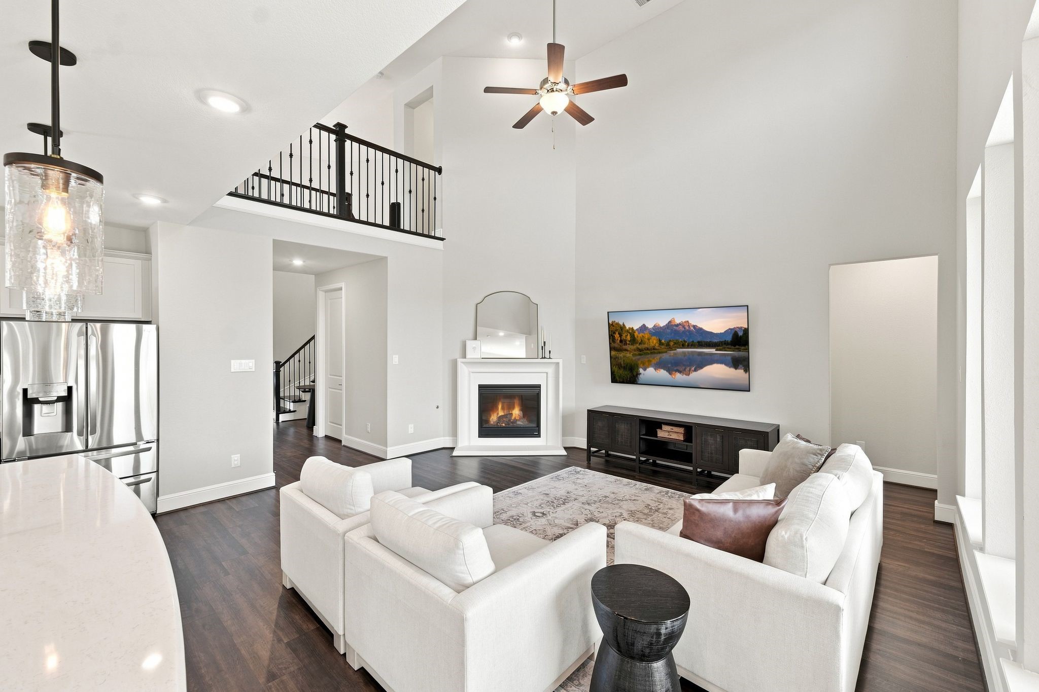 Two-story family room with a full wall of windows and gas fire place with switch start. Two-story family room with a full wall of windows and gas fire place with switch start.