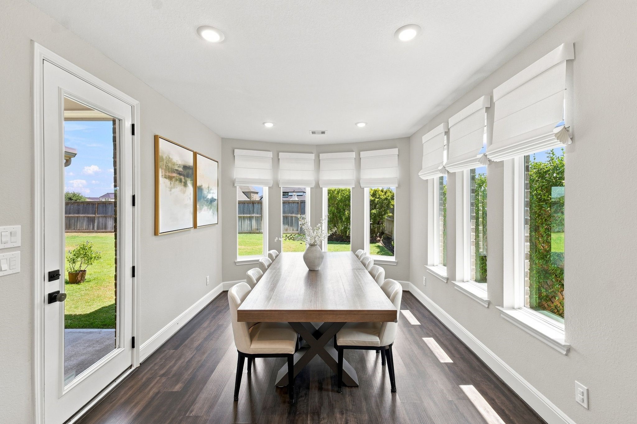Oversized breakfast/dining area with surround window with remote Roman Shades.